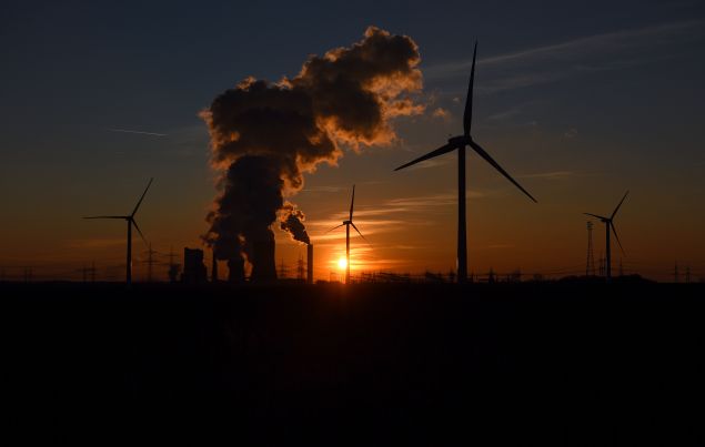  Electricity pylons and wind turbines stand beside the RWE Niederaussem coal-fired power plant while Steam rises from cooling towers on February 16, 2016 near Bergheim, Germany.