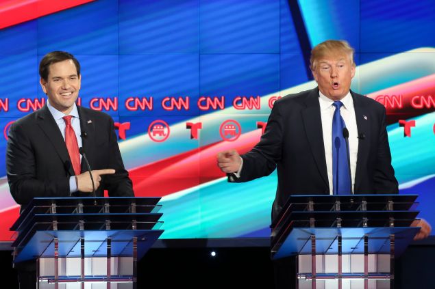 Marco Rubio, left, listens as Donald Trump answers a question during the Republican Presidential Primary Debate at the University of Houston Thursday, Feb. 25, 2016.