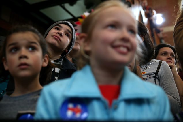 Young supporters look on as democratic presidential candidate former Secretary of State Hillary Clinton speaks during a "Get Out The Vote" rally at the Lyman & Merrie Wood Museum of Springfield History on February 29, 2016 in Springfield, Massachusetts. Hillary Clinton is campaigning in Massachusetts and Virginia ahead of Super Tuesday.
