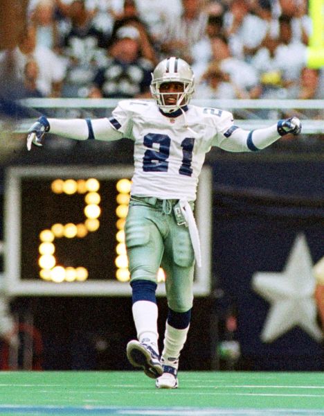 IRVING, UNITED STATES: Deion Sanders of the Dallas Cowboys dances while waiting to return an Arizona Cardinals punt during early action at Texas Stadium in Irving, Texas 03 October 1999. The Cowboys defeated the Cardinals 35-7. AFP PHOTO/Paul BUCK (Photo credit should read PAUL BUCK/AFP/Getty Images)