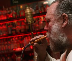 John Garbarini takes a drag on a hookah pipe at Karma, one of the few bars where smoking is still allowed in the East Village, in 2008.