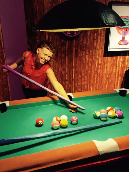 Artist Macon Reed plays pool inside her installation Eulogy for the Dyke Bar, 2015.