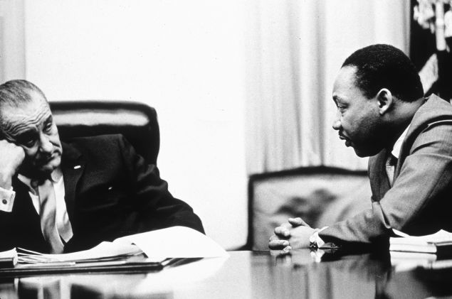 President Lyndon B Johnson (1908 - 1973) discusses the Voting Rights Act with civil rights campaigner Martin Luther King Jr. (1929 - 1968). (Photo by Hulton Archive/Getty Images)