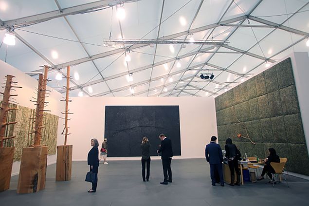 NEW YORK, NY - MAY 17: Art fans look over the instalations at the Frieze art fair at Randalls Island on May 17, 2015 in New York City.