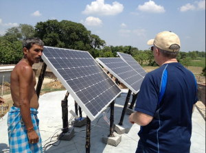 Brad Mattson, CEO of CEO of Siva Power, installs solar panels in an off-grid Indian village