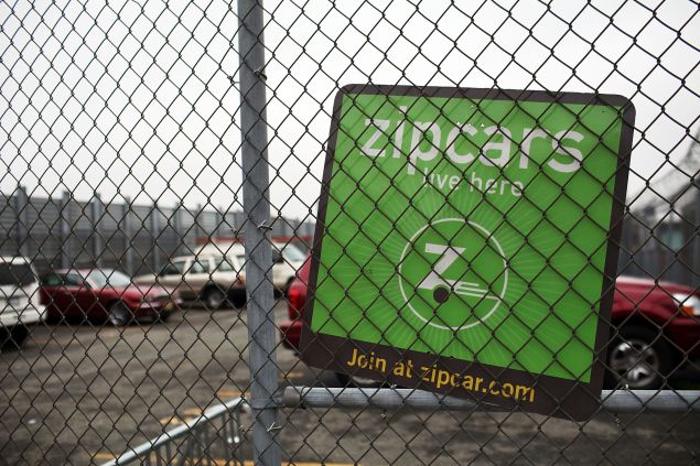 A sign hangs on a parking lot that holds Zipcars on April 13, 2011 in the Brooklyn borough of New York City. Zipcar, a short term car rental company, is set to debut on April 14, on the Nasdaq Stock Market in hopes of raising as much as $133 million under the symbol ZIP. 