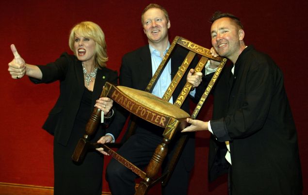 Actress Joanna Lumley (L), Miles Apthorp (C) and actor Rory Bremner (R) pose with the JK Rowling 'Harry Potter' chair at the 2002 Chairish the Child auction
