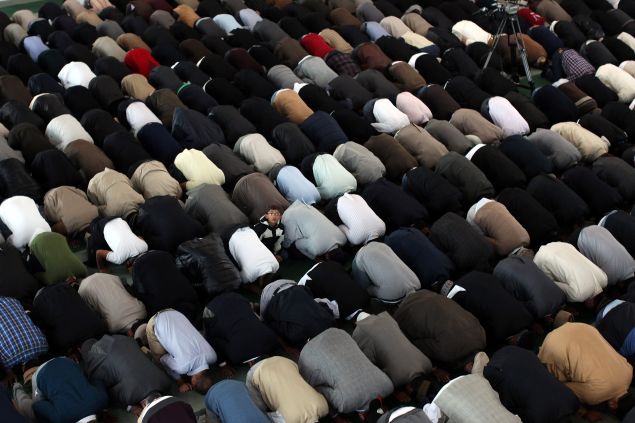 Muslim men pray after a speach by the Islamic Khalifa of the Ahmadiyya Muslim community Mirza Masroor Ahmad at Baitul Futuh Mosque in Morden on September 21, 2012 in London, England.