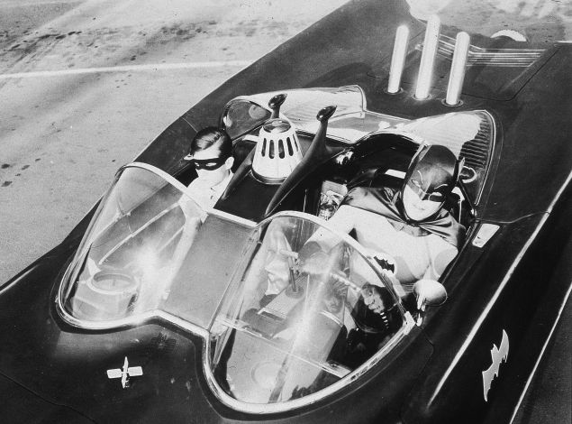 American actors Burt Ward (left), as Robin, and Adam West, as Batman, ride in the Batmobile in a still from the television series, 'Batman,' c. 1967.