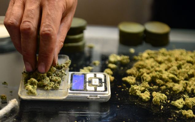A vendor weighs buds for card-carrying medical marijuana patients attending Los Angeles' first-ever cannabis farmer's market at the West Coast Collective medical marijuana dispensary, on the fourth of July, or Independence Day, in Los Angeles, California on July 4, 2014 where organizer's of the 3-day event plan to showcase high quality cannabis from growers and vendors throughout the state. AFP PHOTO/Frederic J. BROWN (Photo credit should read FREDERIC J. BROWN/AFP/Getty Images)