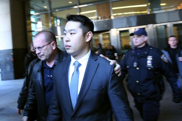 New York City police officer Peter Liang is escorted out of court.