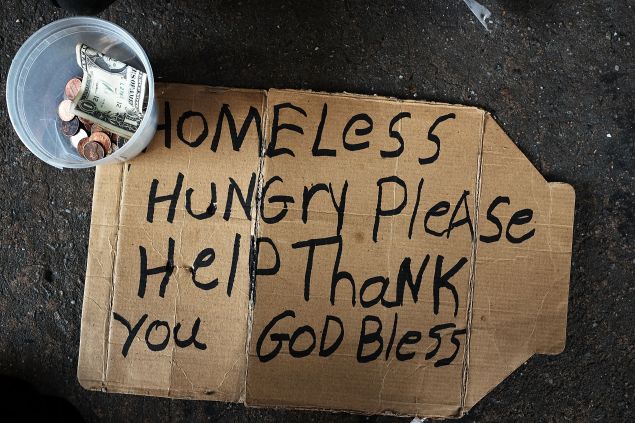 A homeless man's sign rests on the street on December 21, 2015 in New York City.