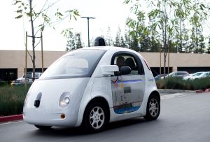 A self-driving car traverses a parking lot at Google's headquarters in Mountain View, California on January 8, 2015. 