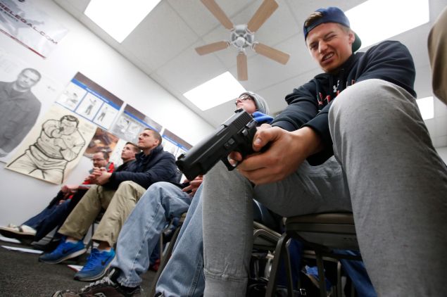 Jaden Adams person look over a unloaded semi automatic handgun during a class to obtain the Utah concealed gun carry permit, at Range Master of Utah, on January 9, 2016 in Springville, Utah. Utahs permits, available for a fee to non-residents who meet certain requirements, are among the most popular in the country because they are recognized in more than 30 states.