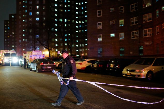A New York Police officer demarcates a crime scene in the Bronx.