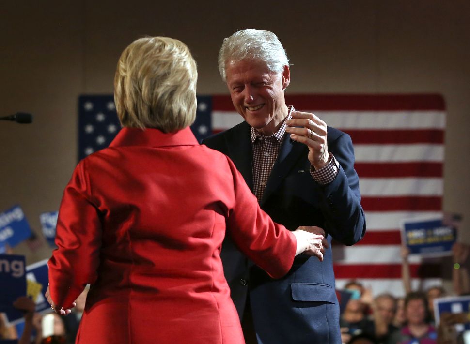 Democratic presidential candidate former Secretary of State Hillary Clinton embraces her husband former U.S. president Bill Clinton during a caucus day event at Caesers Palace on February 20, 2016 in Las Vegas, Nevada. Hillary Clinton defeated Democratic rival U.S.Sen Bernie Sanders in the Nevada Democratic caucuses. 