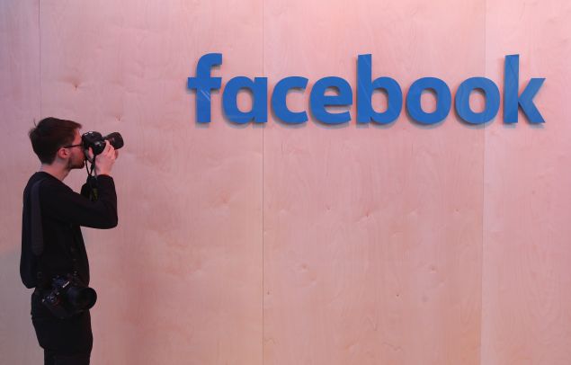 A photographer snaps a photo of the Facebook logo at the Facebook Innovation Hub on February 24, 2016 in Berlin, Germany. The Facebook Innovation Hub is a temporary exhibition space where the company is showcasing some of its newest technologies and projects.