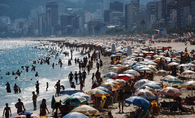 People gather on Ipanema beach, a landmark tourist destination in Rio, on February 26, 2016 in Rio de Janeiro, Brazil. The Zika virus outbreak, which may be linked to a surge in microcephaly cases in the country, is threatening tourism in Brazil which expects to profit from hundreds of thousands of foreign visitors travelling to Rio de Janeiro during the Rio 2016 Olympic Games. The World Health Organization (WHO) has declared the outbreak, centered in Brazil, to be a 'public health emergency of international concern'. 