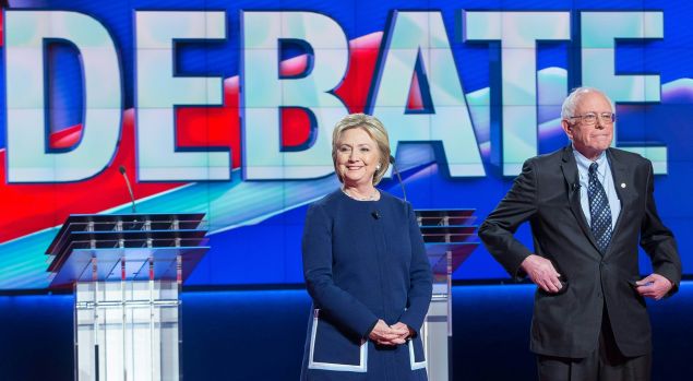 Democratic presidential candidates Hillary Clinton and Bernie Sanders await the start of the Democratic Debate in Flint, Michigan, March 6, 2016.
