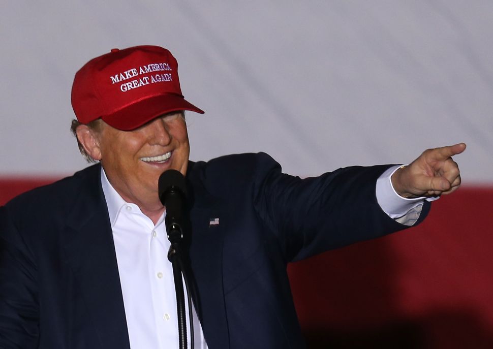 Republican presidential candidate Donald Trump speaks as he attends his campaign rally at the Sunset Cove Amphitheater on March 13, 2016 in Boca Raton, Florida. Trump continues to campaign before the March 15 Florida primary.