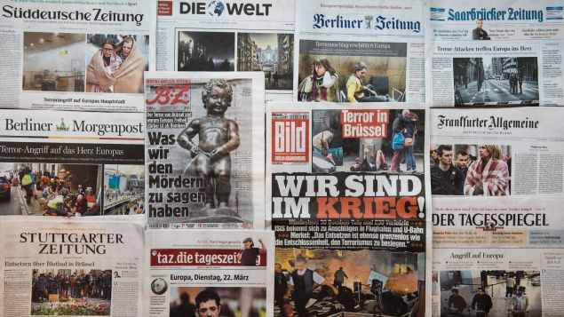 A picture taken on March 23, 2016 in Berlin shows the frontpage of several newspapers, one day after some 35 people were killed in bombings at Zaventem Airport and on a metro train.