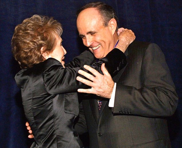 Former New York Mayor Rudy Giuliani (R) is presented the Ronald Reagan Freedom Award by former First Lady Nancy Reagan during a mock ceremony before a dinner in his honor in Beverly Hills, 08 March 2002.