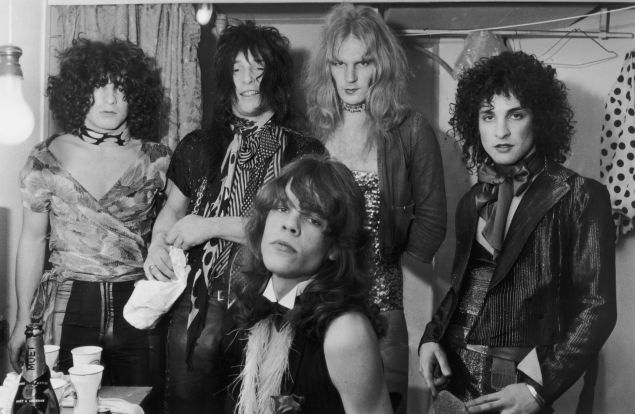 Influential American glam rock band the New York Dolls in their dressing room, 30th October 1972. Standing, left to right: Jerry Nolan, Johnny Thunders, Killer Kane and Sylvain Sylvain. Seated: singer David Johannson. 