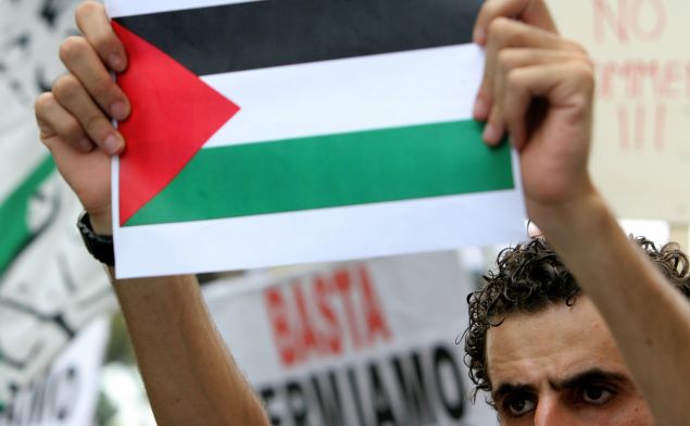 A demonstrator holding a Palestinian flag protests during a rally in Rome 27 July 2006, to show solidarity with the Lebanese and Palestinian people. Many countries around the world have been witnessing anti-Israeli demonstrations since the Israeli offensive began against Lebanon sixteen days ago.