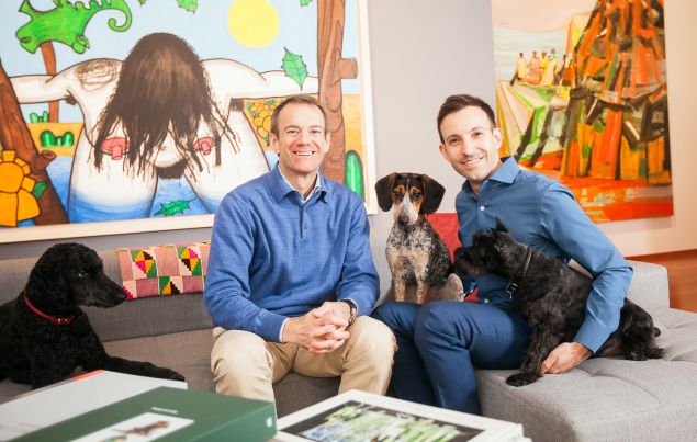 Greg Miller and Michael Wiener with (L to R) Jetson, Mukti and Frisbee in their living room with Carroll Dunham, Next bathers, four (wash), (2012) and Amy Sillman, Regarding Saturna, (2005).