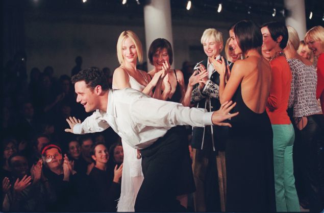 Isaac Mizrahi takes a bow on the runway with his models at the showing of his 1997 Spring collection.