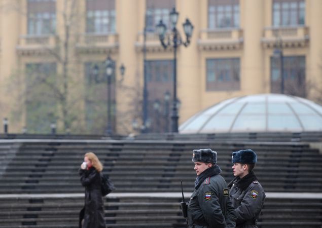 Russian police officers patrol on Manezhnaya Square outside the Kremlin in Moscow on November 9, 2010.