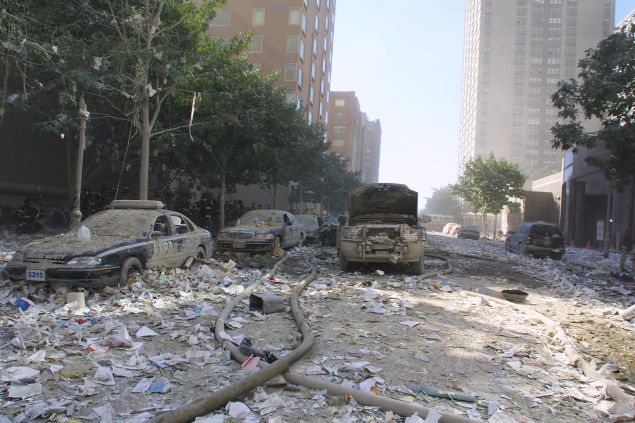 Debris covers cars at the World Trade Center after two hijacked planes crashed into the Twin Towers September 11, 2001 in New York.