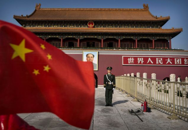 A Chinese soldier stands guard in front of Tiananmen Gate outside the Forbidden City on October 27, 2014 in Beijing, China.