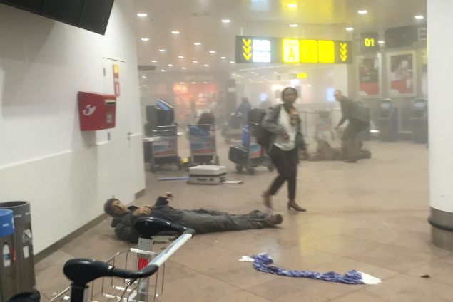 An injured man lies among debris following a suicide bombing at Brussels Zaventem airport last month.