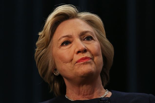 Democratic presidential candidate Hillary Clinton pauses at a rally with New York Governor Andrew Cuomo after he signed a law that will gradually raise the stateÕs minimum wage to $15 while also establishing paid family leave for New York workers on April 4, 2016 in New York City. Supported by unions, workers and progressives across the state, Cuomo stated that the current minimum wage of $9 an hour is too low to support a family. the event was held at the Jacob Javits Convention Center.