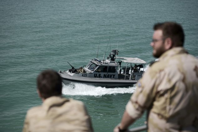 Navy sailors from The Netherlands watch training exercises from aboard the Choctaw County, a new U.S. Navy non-combatant vessel that has a civilian crew to provide maritime security, crisis response and troop transport, in the Gulf off the coast of Bahrain's capital Manama on April 10, 2016 The Bahrain-based U.S. Naval Forces Central Command is leading the International Mine Countermeasures Exercise