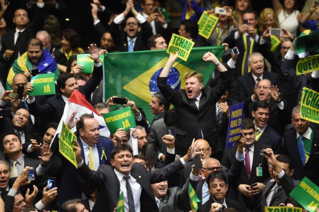 Brazil's lawmakers celebrate after they reached the votes needed to authorize President Dilma Rousseff's impeachment to go ahead, at the Congress in Brasilia on April 17, 2016.