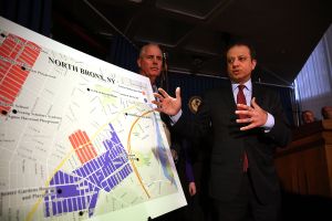 United States attorney Preet Bharara gestures at a map showing where 120 people were arrested on gang-related charges in the Bronx