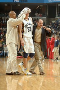 MEMPHIS, TN - NOVEMBER 25: Mike Miller #33 of the Memphis Grizzlies leaves the court after suffering a concussion and a laceration above his left eye during a scramble for the ball in the first quarter of the game against the Houston Rockets on November 25, 2005 at FedExForum in Memphis, Tennessee. The Grizzlies won 86-81. Miller did not return for the rest of the game. NOTE TO USER: User expressly acknowledges and agrees that, by downloading and or using this photograph, User is consenting to the terms and conditions of the Getty Images License Agreement. Mandatory Copyright Notice: Copyright 2005 NBAE