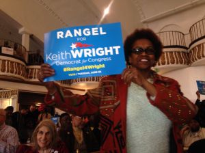 A woman holds a "Rangel for Keith Wright" sign.