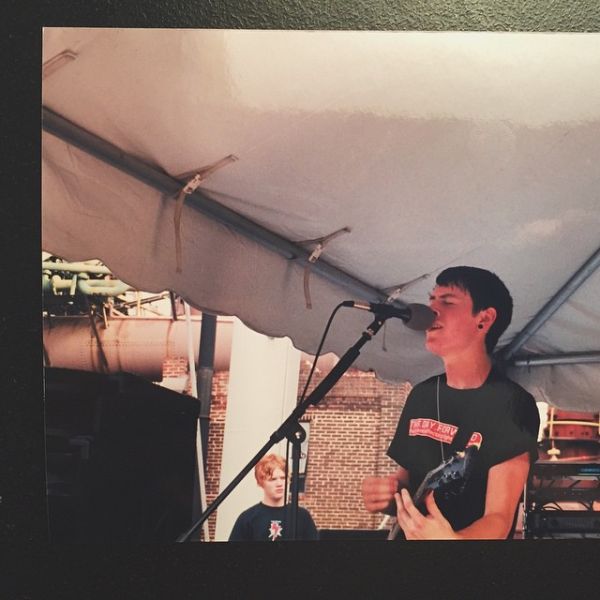 Ryan Burleson (foreground) playing with his band, Embraced, in 2002, with Aaron Gillespie (background) of Underoath watching from backstage.