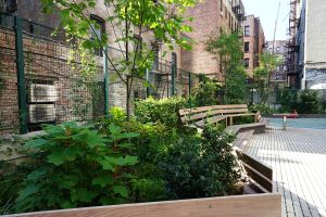23888 Creston Avenue's courtyard boasts a performance space, bench seating and raised garden beds.