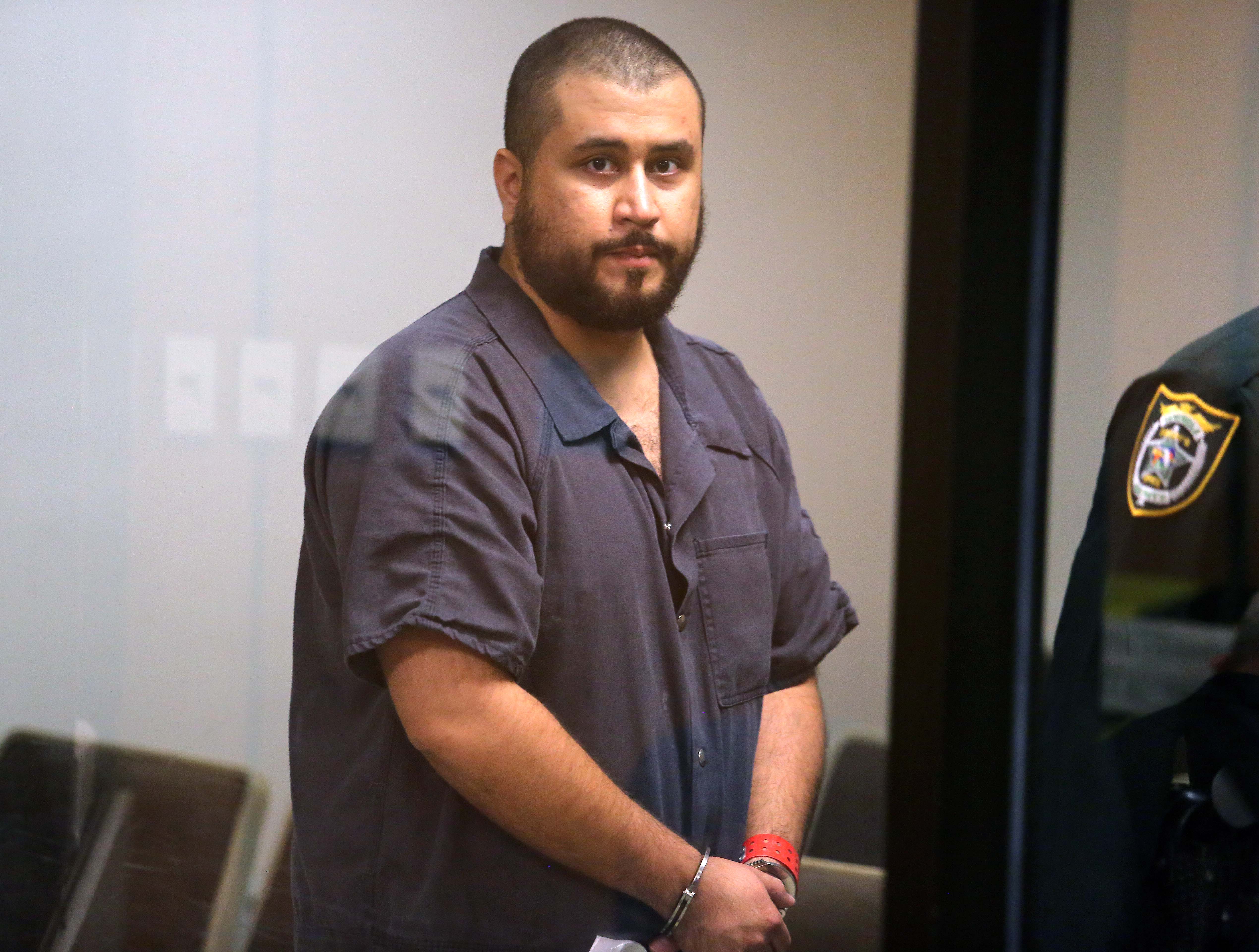 SANFORD, FL - NOVEMBER 19: George Zimmerman, the acquitted shooter in the death of Trayvon Martin, arrives in Courtroom J2 to face a Seminole circuit judge during a first-appearance hearing on charges including aggravated assault stemming from a fight with his girlfriend November 19, 2013 in Sanford, Florida. Zimmerman, 30, was arrested after police responded to a domestic disturbance call at a house. He was acquitted in July of all charges in the shooting death of unarmed, black teenager, Trayvon Martin.