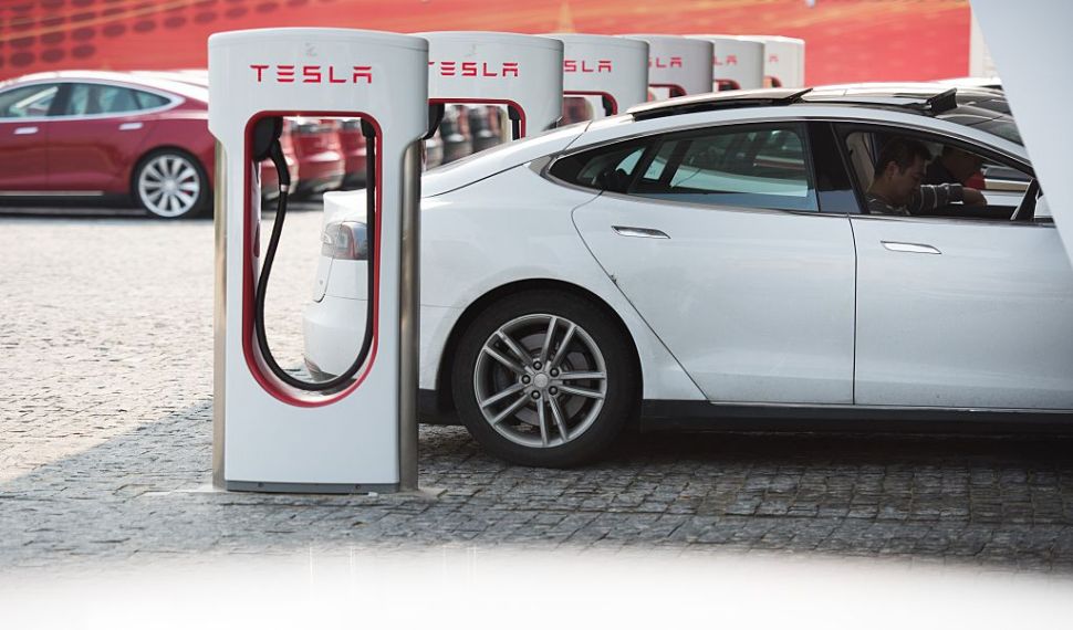 This picture taken on March 17, 2015 shows a Tesla Model S being charged at a car dealership in Shanghai. Serial entrepreneur Elon Musk has launched spacecraft into orbit, but popularising his Tesla electric cars in China is proving to be tougher than rocket science.