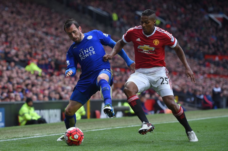 Christian Fuchs of Leicester City holds off Antonio Valencia of Manchester United during the Barclays Premier League match between Manchester United and Leicester City at Old Trafford on May 1, 2016 in Manchester, England.
