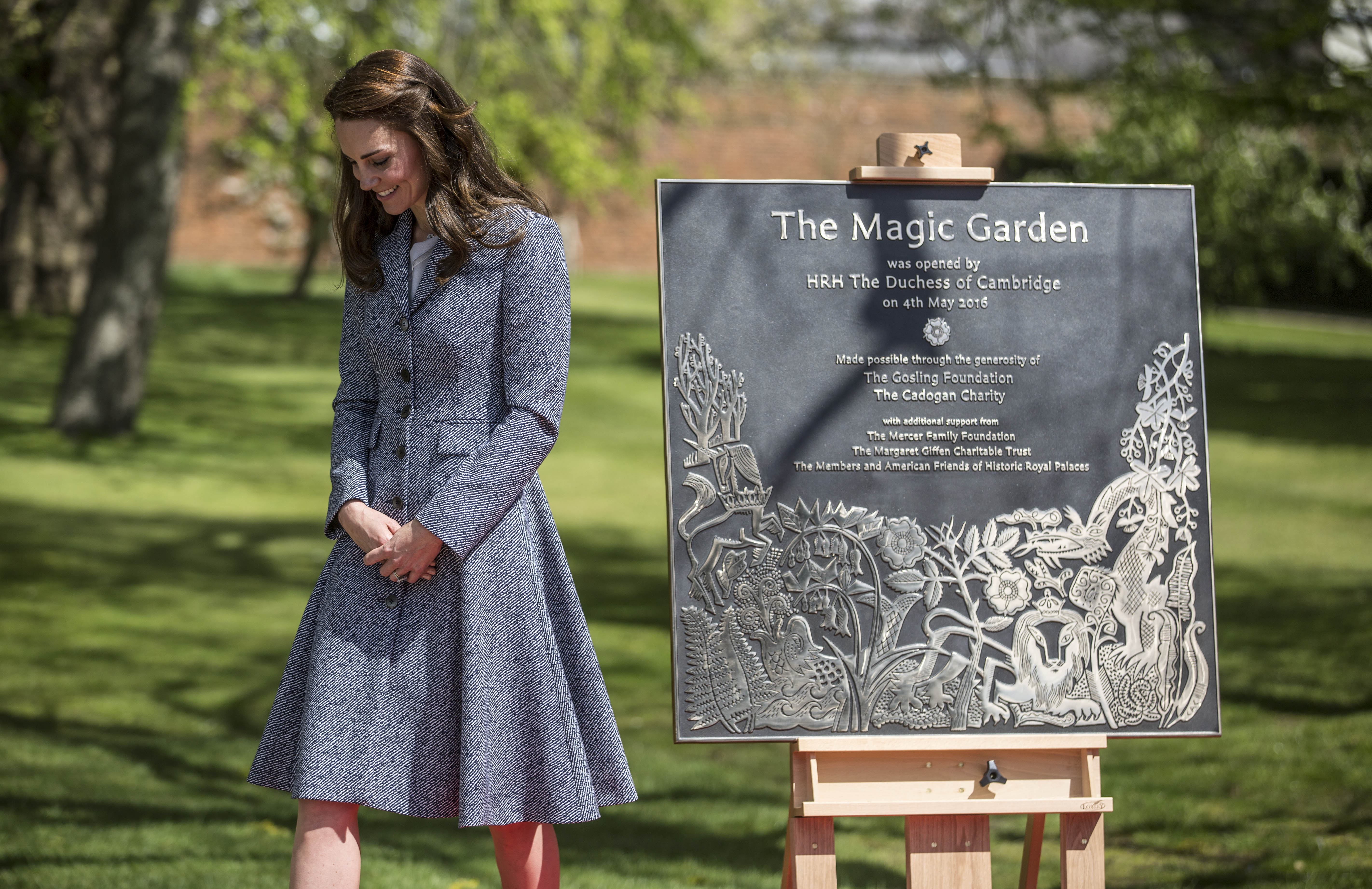 LONDON, ENGLAND - MAY 04: Catherine, Duchess of Cambridge stands with the plaque she unveiled as she officially opens The Magic Garden at Hampton Court Palace on May 4, 2016 in London, England.