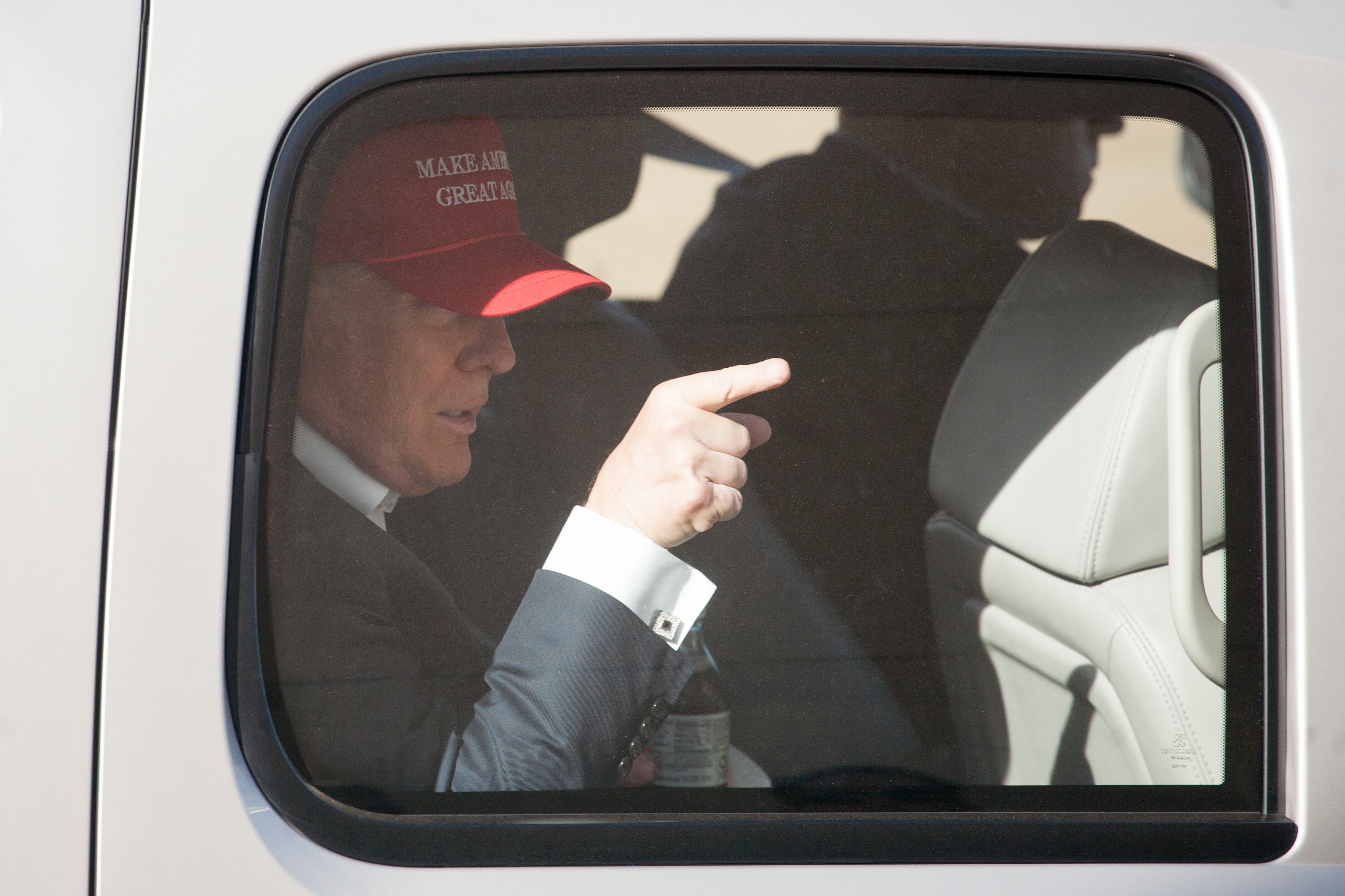Republican presidential candidate Donald Trump gestures from his motorcade after a rally at the The Northwest Washington Fair and Event Center on May 7, 2016 in Lynden, Washington. Trump became the Republican presumptive nominee following his landslide win in Indiana on Tuesday.