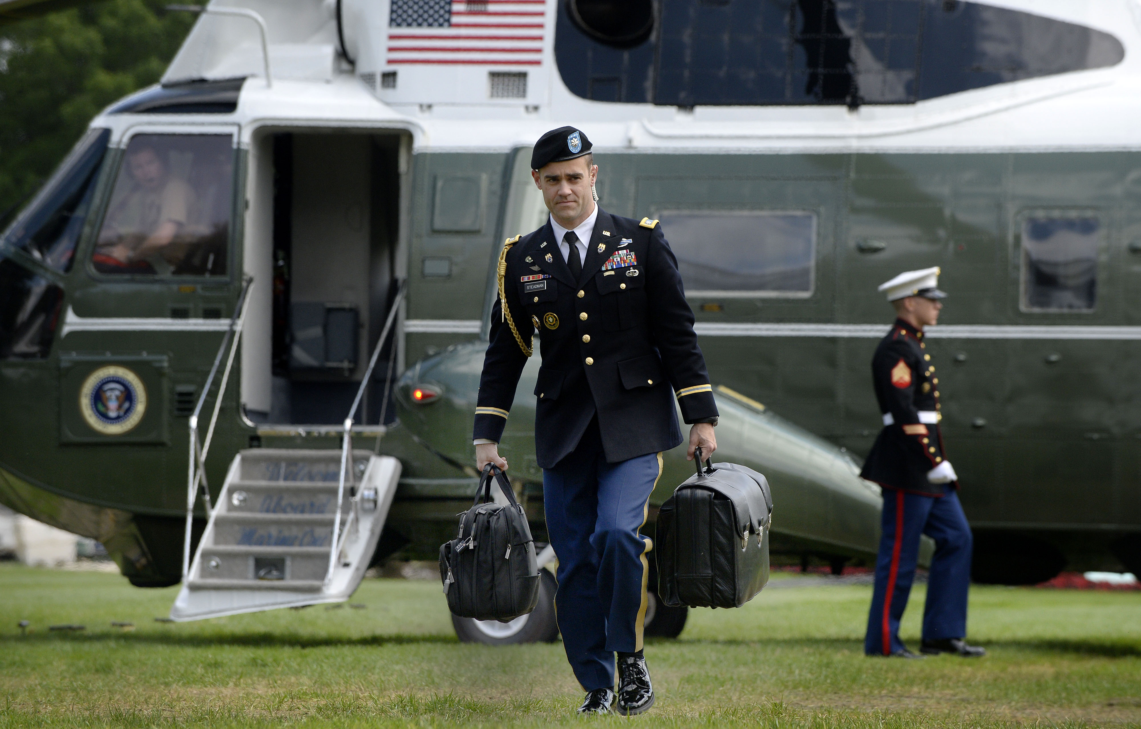 A soldier carries the briefcase containing nuclear weapons codes for U.S. President Barack Obama