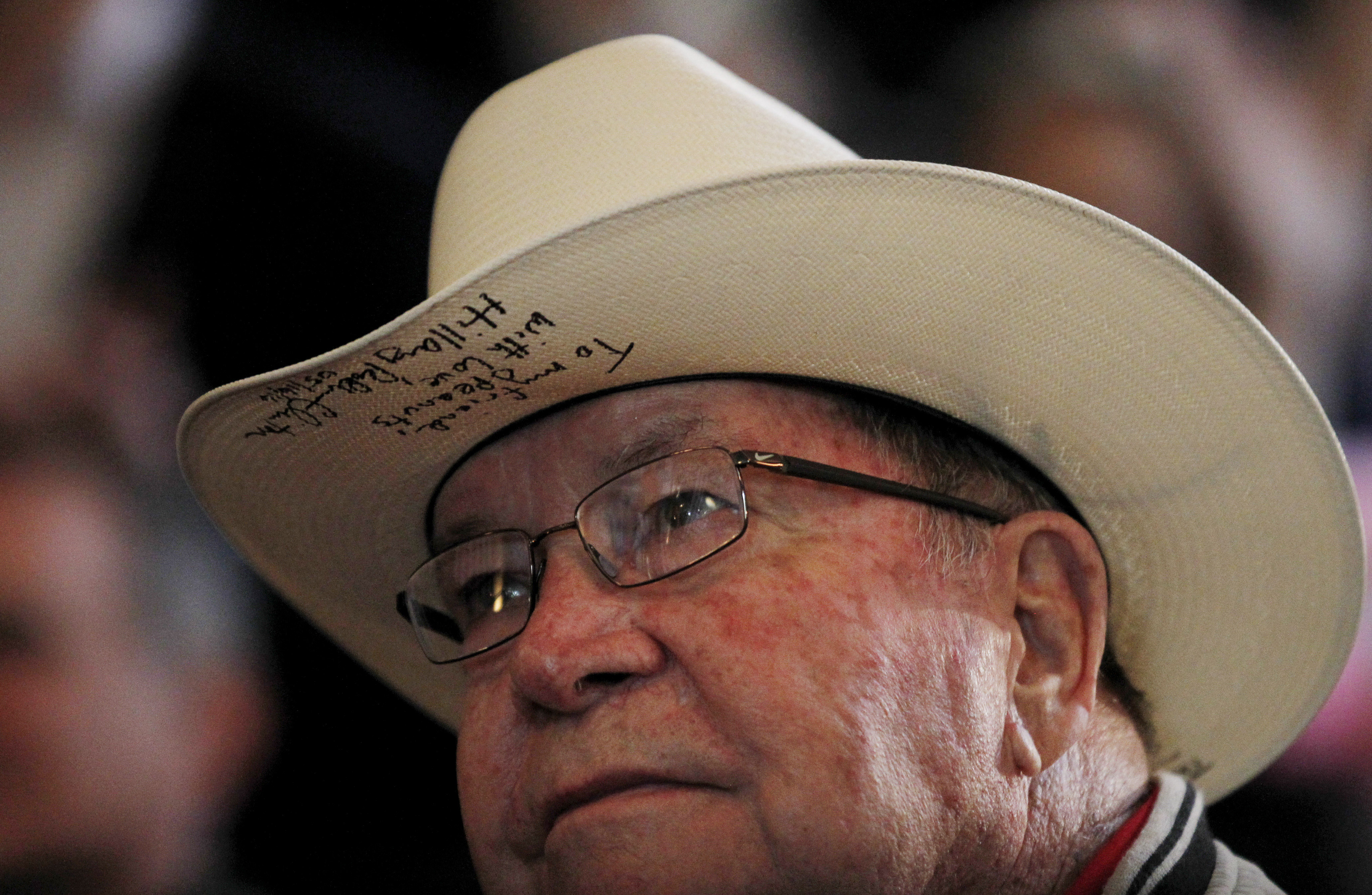 A campaign supporter wares his cowboy hat that was signed by Democratic presidential candidate Hillary Clinton as he listens to her speak during a campaign rally at La Gala May 16, 2016, in Bowling Green, Kentucky. Clinton is preparing for Kentucky's May 17th primary.