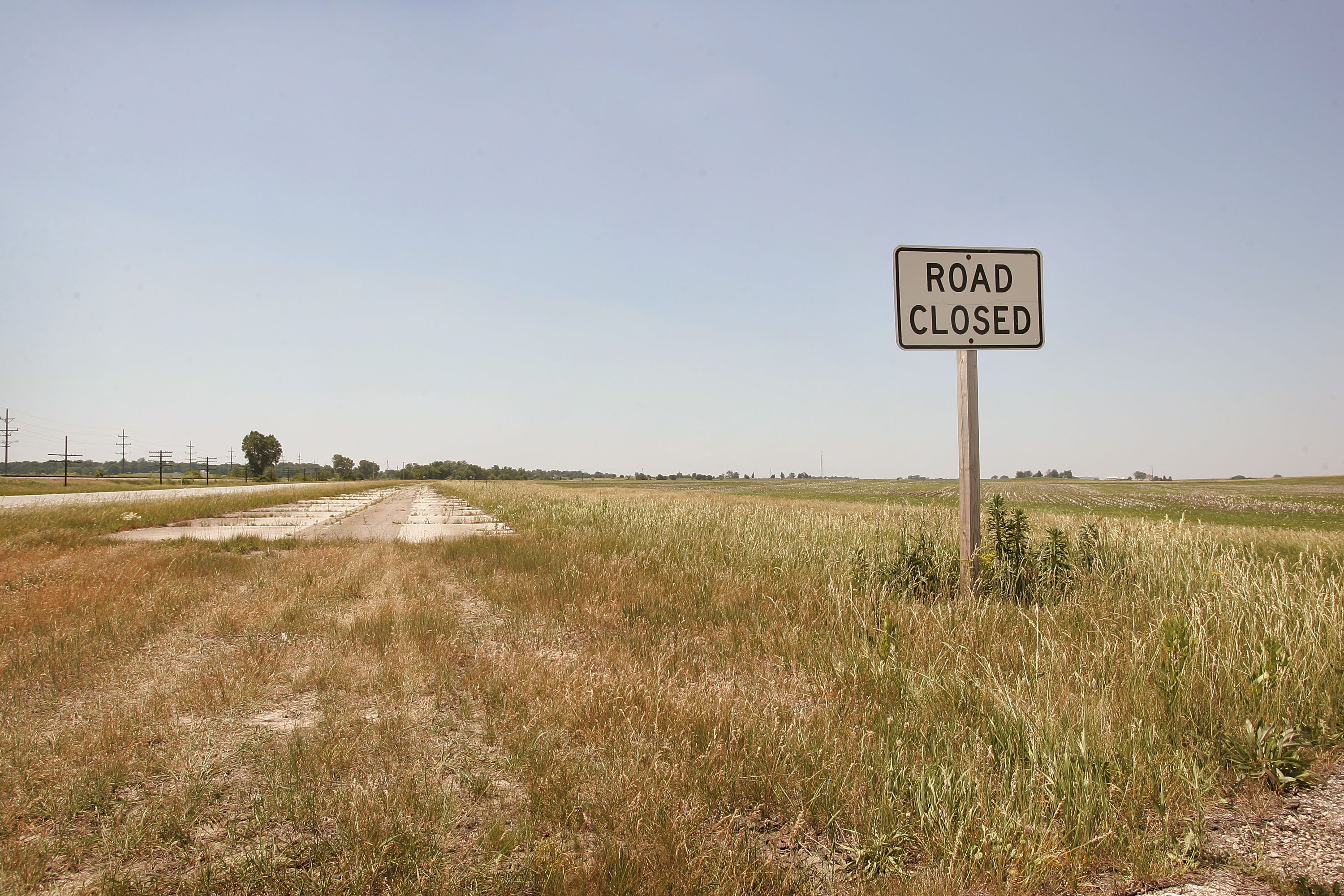 DWIGHT, IL - JUNE 13: A sign declares an old section of historic U.S. Route 66 closed June 13, 2007 near Dwight, Illinois. Route 66 opened in 1926 stretching from Chicago to Los Angeles and became a western migration route for people looking for work during the great depression of the 1930's or to escape the Dust Bowl disaster. Later it offered vacation getaways and driving adventures until 1985 when it was decommissioned as a federal highway. Due to neglect and commercial development Route 66, the first highway to connect the Midwest with the West Coast, has recently been added to the biennially compiled list of the world's most endangered landmarks by the World Monuments Fund and the National Trust for Historic Preservation's yearly list of the 11 most endangered historic places in America.